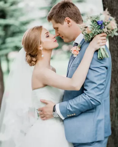 The bride and groom, dressed up, look at each other